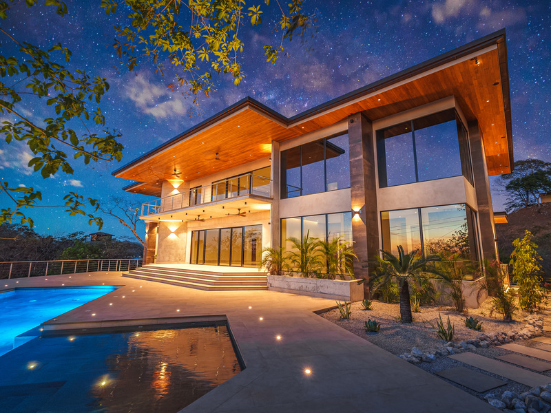 guanacaste real estate showing the front of the home in el palacete with sunset and stars in the background