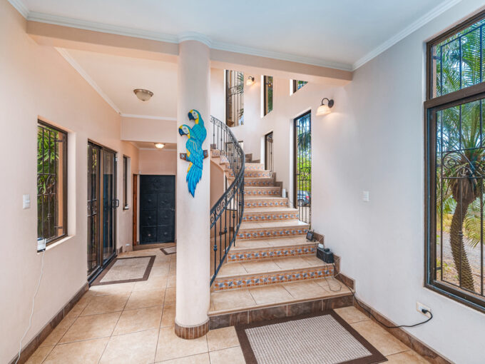 casa palacio interior with white tile flooring and staricase